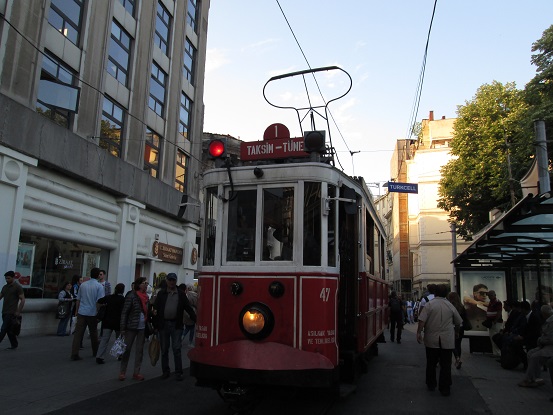Serious Theory: That tram's job is pushing people out of the way.